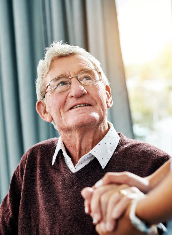 nurse holding hands with a senior patient