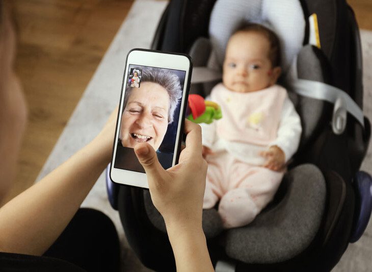 grandma on a video call with her infant grandchild