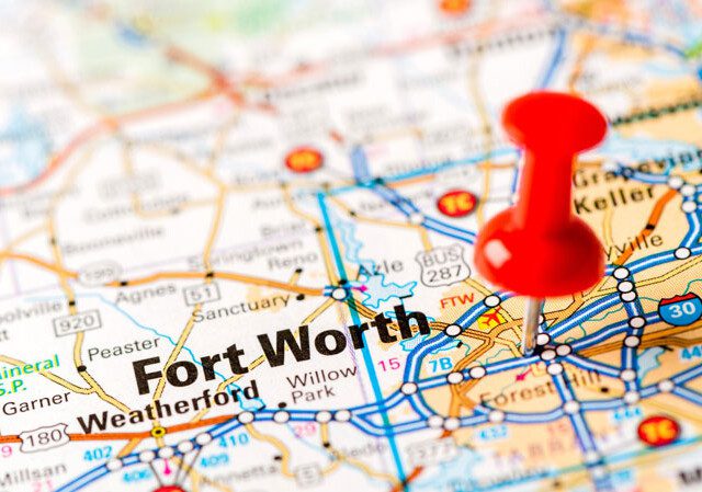 close up of a map with a pin stuck in the Fort Worth area