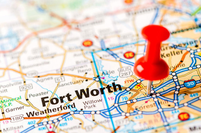 close up of a map with a pin stuck in the Fort Worth area