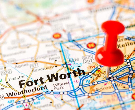 close up of a map with a pin stuck in the Fort Worth area