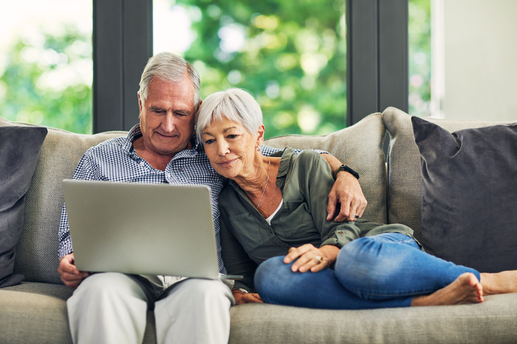 couple using a laptop on the sofa