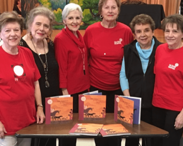 six senior women at a book signing