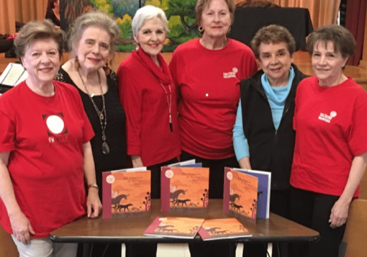 six senior women at a book signing
