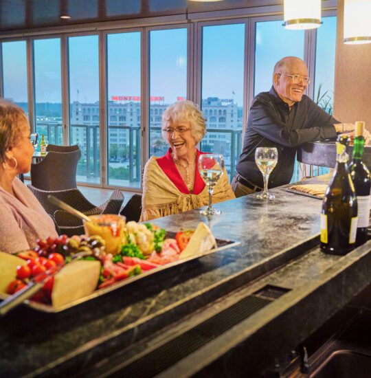 residents having a drink and a conversation in the bar at The Stayton