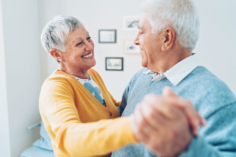 Older couple smiling and dancing