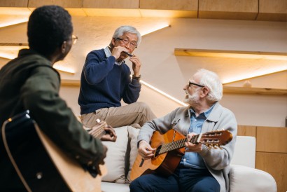 Group of seniors playing music at their senior living community