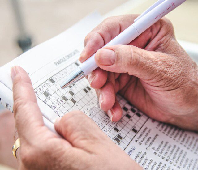 resident doing a crossword puzzle to keep their brain sharp