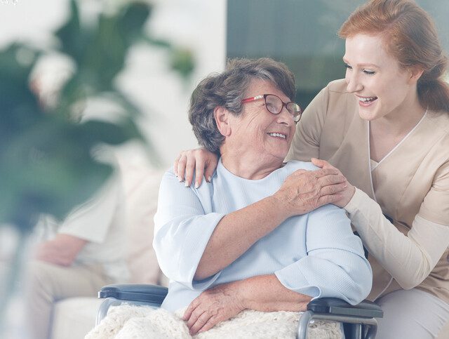 Happy patient holding caregivers hand while spending time together