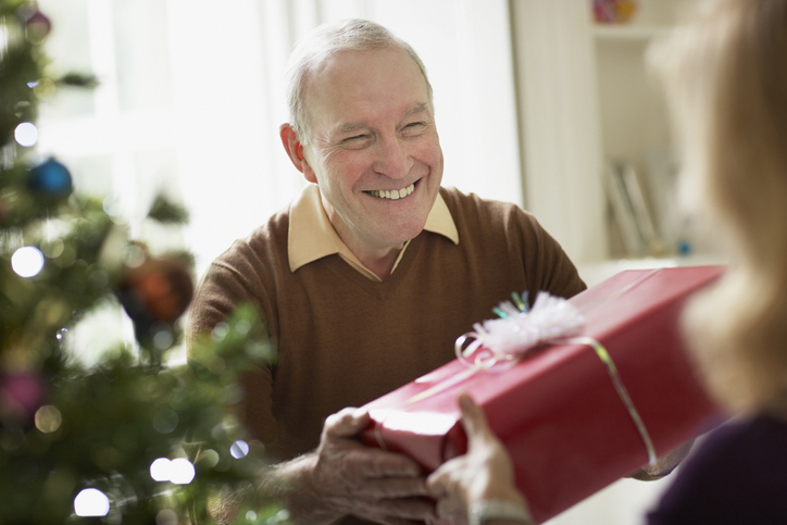 Senior man giving wife Christmas gift