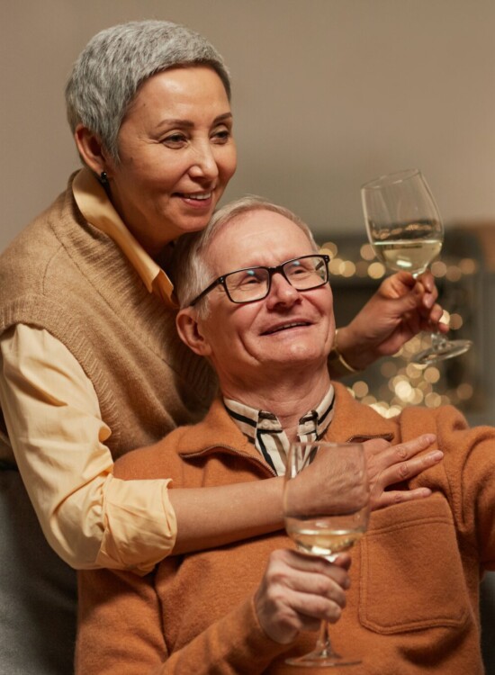 Couple taking a selfie while enjoying some wine.