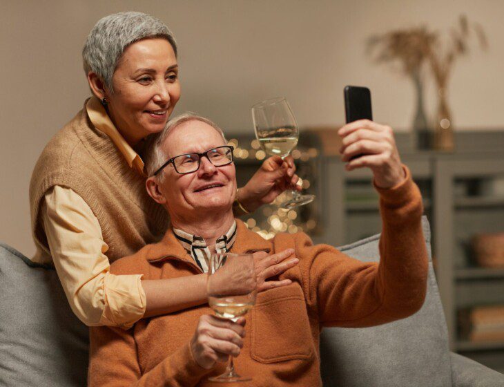 couple taking a selfie while enjoying some wine