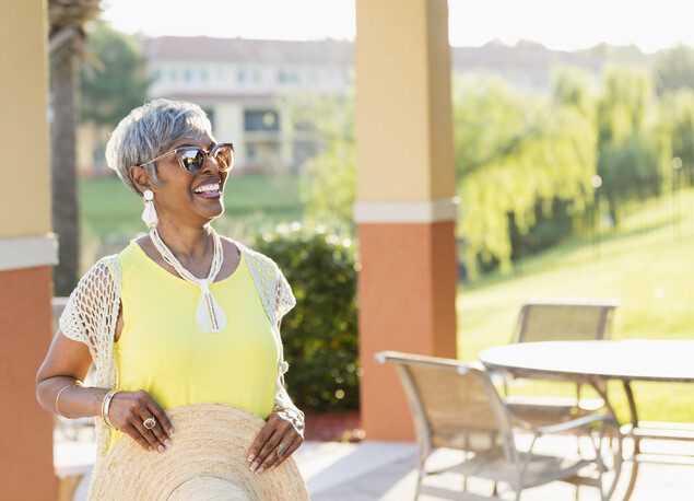 Senior woman happily smiling while outside.