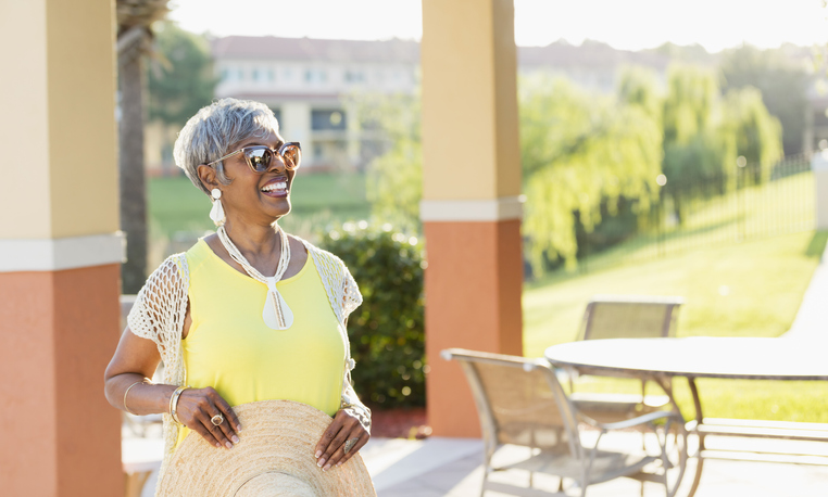 Senior woman happily smiling while outside.