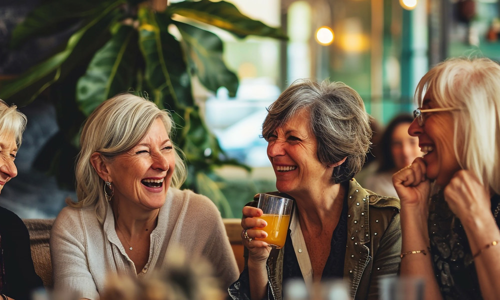 Group of elderly woman having dinner together while grinning. 2