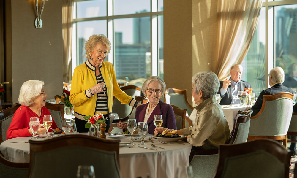 group of elderly woman having an elegant dinner together.