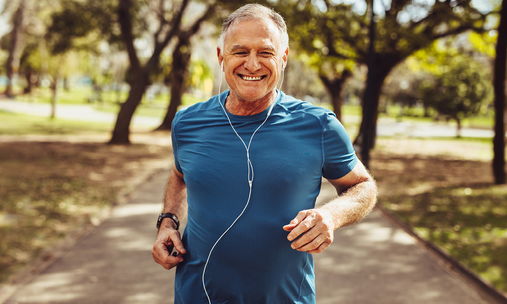 Man smiling while on a outdoor run.